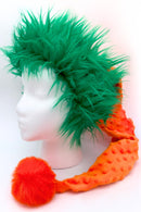 A mannequin head wearing a playful costume (Santa-style) hat with bright green spiky faux fur trim, attached to a long orange textured tail ending in a fluffy red-orange pom-pom.