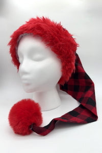 Red and black (buffalo) plaid Santa-style hat with a fluffy red faux fur brim and large red pom-pom, displayed on a white mannequin head.