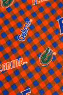 Orange and blue plaid fabric patterned with University of Florida Gators logos, including the word “Florida,” the script “Gators,” a large blue “F,” and the green alligator head mascot.