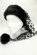 A mannequin head wearing a long, pointed winter hat with a thick black faux fur trim and pom-pom. The body of the hat is gray with a black leopard print pattern, extending down to one side.