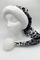 A gray and black leopard-print Santa-style hat with a fluffy white faux fur brim and a large white pom-pom at the end, displayed on a white mannequin head against a plain background.