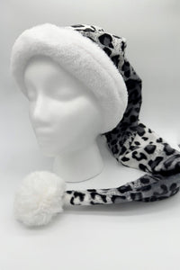 A gray and black leopard-print Santa-style hat with a fluffy white faux fur brim and a large white pom-pom at the end, displayed on a white mannequin head against a plain background.