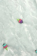 Light blue furry textured fabric with two small decorative patches shaped like colorful ice cream cones, one with purple and pink scoops and the other with turquoise and pink scoops, both with green cones.