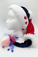 Hat on a manequin with alternating red and blue sections separated by white faux fur and finished wth a tule ribbon of red, white and blue