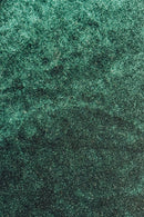 Close-up of dark green Velvet fabric with a wavy, iridescent sheen.