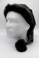 Camouflage Santa-style hat with black faux fur trim and a matching black pom-pom, displayed on a white mannequin head.