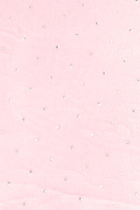 Light pink fabric with a scattered pattern of small, round silver rhinestones evenly spaced across the surface.