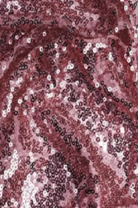 Close-up of shimmering pink and rose-colored sequin fabric with light reflecting off the sequins, creating a sparkling, textured surface.