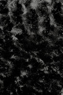 Close-up view of a black panne Velvet fabric.  The panne Velvet is soft, shiny, and has slightly wavy pattern reflecting light.