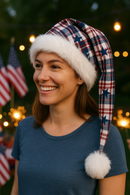 Adult wearing handmade red, white & blue plaid holiday hat with stars, white faux fur trim, and fluffy white pom-pom in a patriotic celebration scene.