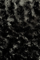 Close-up view of a black panne Velvet fabric.  The panne Velvet is soft, shiny, and has slightly wavy pattern reflecting light.