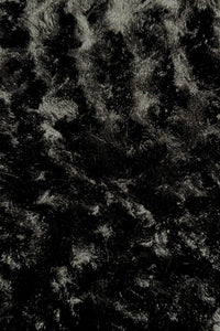 Close-up view of a black panne Velvet fabric.  The panne Velvet is soft, shiny, and has slightly wavy pattern reflecting light.