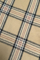 Close-up of a beige fabric with a plaid pattern, featuring intersecting black, white, and brown lines forming squares. This fabric is commonly referred to as Burberry.