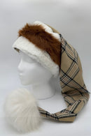 Burberry plaid fabric hat with a fluffy white pom-pom at the tip, white faux fur trim, and a section of reddish-brown faux fur, displayed on a white mannequin head.